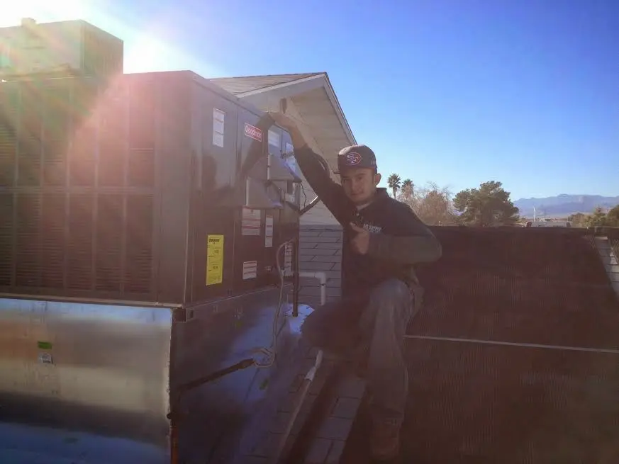 HVAC technician performing Air Duct Repair on a rooftop unit in Crest Hill